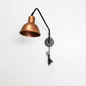 Modern plug in <b>wall</b> <b>sconce</b> with an angled black metal arm and warm copper shade Designed for focused task <b>lighting</b> while - Product Image 1