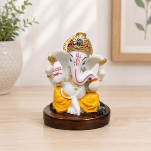 Statue artisanale traditionnelle du Dieu Ganesha en résine blanche avec couronne dorée et dhoti jaune pour la décoration intérieure et les figures spirituelles - Product Image 1