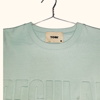 T-shirt en coton tissé 100 % respirant à col rond pour l'été, léger et confortable pour le quotidien, avec logo imprimé en relief – Grande Vente