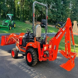 Potente tractor Kubota BX23S con sistema hidráulico de alta resistencia, cargador frontal, retroexcavadora y cómoda cabina de control para el operador. - Product Image 1