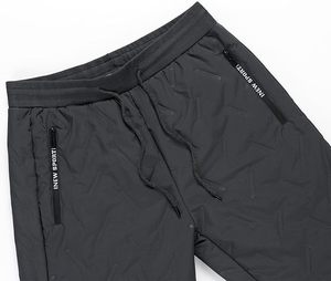 Pantalones de nieve acolchados para hombre, negros, con forro polar, cintura con cordón y bolsillos con cremallera - Product Image 5