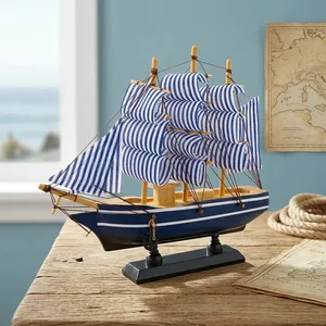 Modèle de bateau à voile en bois artisanal avec décorations nautiques rayées bleues et blanches, avec support de présentation pour table ou maison - Product Image 1