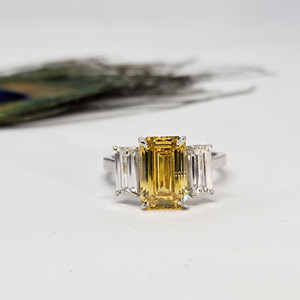 Anillo de compromiso de tres piedras con diamante amarillo de corte esmeralda cultivado en laboratorio, con diamantes laterales de baguette cónicos en oro blanco macizo de lujo - Product Image 1