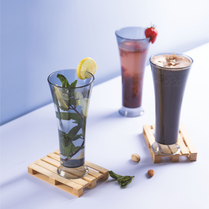 Vaso transparente para beber, colocado sobre una superficie de madera con un diseño claro, ideal para servir agua, jugo o bebidas en un estilo moderno. - Product Image 3
