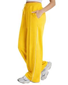 Pantalon de jogging ample jaune pour femme en molleton avec passepoil latéral, taille élastique et cordon de serrage, coupe décontractée, idéal pour la détente - Product Image 1