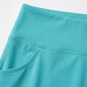 Jupe courte asymétrique taille haute pour femme avec poches, couleur unie, style sportif, tissu respirant en spandex et polyester - Product Image 4