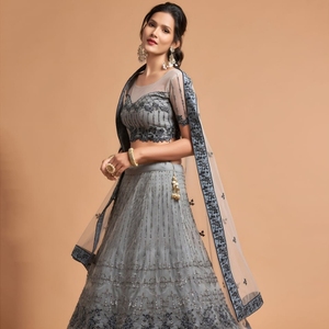 El lehenga semicompuesto en forma de A está hecho de tela de red suave de primera calidad y adornado con intrincados detalles de hilo zari badla dori. - Product Image 1