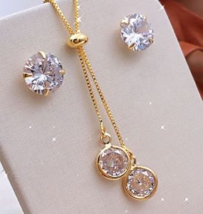 Parure de bijoux en zircon plaqué or avec pendentif et boucles d'oreilles à griffes rondes pour anniversaire et mariage - Product Image 1