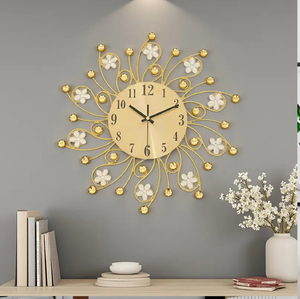 Beautiful gold starburst wall clock features a circular face and elegant white metal flowers, available at wholesale prices. - Product Image 1