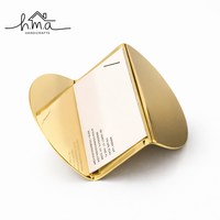 Ensemble de porte-cartes géométriques en or rose, comprenant des modèles cube, pyramide et hexagone, supports de table modernes et minimalistes