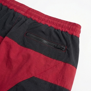 Pantalones Jogger Rojos y Negros al por Mayor, Pantalones Cortavientos de Nailon con Cremalleras Utilitarias, Proveedor OEM de Ropa Urbana y Deportiva - Product Image 3