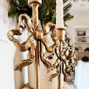 Elegantes candelabros de hierro fundido dorado, juego de dos soportes decorativos en forma de lazo para decoración de mesas en bodas y fiestas. - Product Image 4