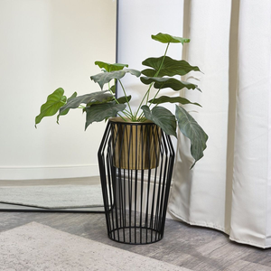 Stunning gold planter nestled in a black geometric <b>wire</b> hourglass stand available at wholesale prices for modern homes. - Product Image 1