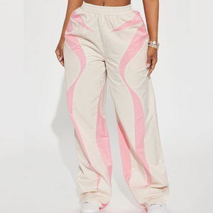 Pantalon parachute blanc ample pour femme avec logo personnalisé, coupe basse, cordon de serrage, coupe-vent en nylon, idéal pour l'hiver - Product Image 1