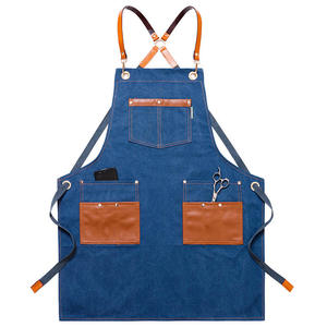 Delantal de peluquería de mezclilla con bolsillos de cuero, correas ajustables para uso en barberías y salones, diferentes colores y logotipos personalizados. - Product Image 1