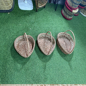 Two-toned <b>rectangular</b> seagrass <b>storage</b> <b>basket</b> with a hinged flat lid, styled on a light wooden floor against a textured wall. - Product Image 6