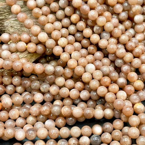 ลูกปัดมูนสโตนสีน้ำตาลธรรมชาติ รูปทรงกลม สีน้ำตาลเทาพีชสวยงาม พร้อมประกายแสงธรรมชาติ ร้อยเป็นเส้นเต็ม - Product Image 1