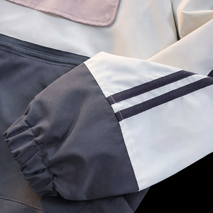 Chaqueta cortavientos unisex ligera con capucha, bloques de color y bolsillo canguro. - Product Image 6