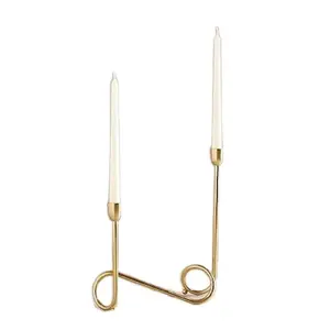 Metal Loop Candelabra Set Loops of polished brass create a deceptively simple modern candelabra with airy curves.