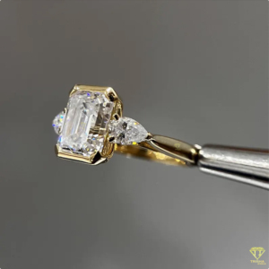 Elegant <b>Emerald</b> Cut Lab Grown Diamond Engagement <b>Ring</b> With Pear Side Stones In Yellow Gold For Women - Product Image 1