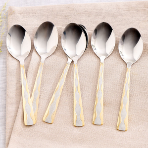 Stunning stainless steel spoons, beautiful wavy gold <b>border</b> handles, top quality finish, available at wholesale prices. - Product Image 1