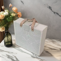 Boîte cadeau en EVA de luxe en forme de livre, avec logo en feuille d'or, texture gaufrée élégante, laminage mat pour crème pour le visage, produits de luxe personnalisés