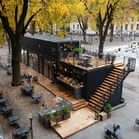 Restaurant en conteneur noir à deux étages EC-20TP avec terrasse en bois pour projets commerciaux