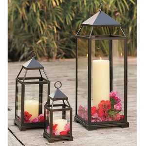 Black metal <b>lantern</b> <b>set</b> with glass panels pyramid top circular ring white pillar candles red and pink flower petals - Product Image 1