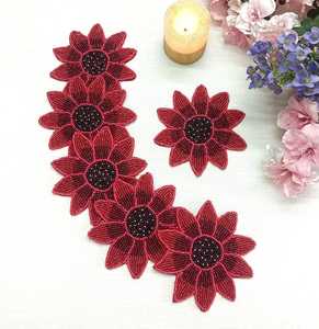 A set of 6 handmade red flower-shaped beaded coasters. - Product Image 1