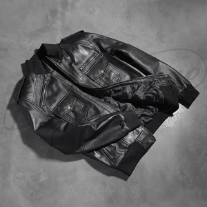 Sleek black genuine <b>leather</b> construction featuring a utility pocket and a traditional ribbed baseball collar. - Product Image 3