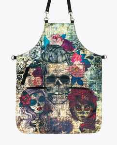 Delantal con diseño de calavera del Día de los Muertos, con correas ajustables y bolsillos negros para peluquería - Product Image 1
