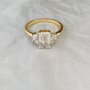 Exquisite <b>Emerald</b> Diamond <b>Ring</b> with Side Stones, Set in Elegant Yellow Gold – A Perfect Blend of Luxury and Timeless Beauty - Product Image 1