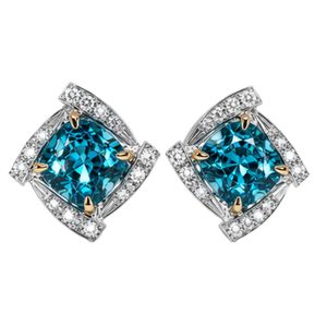 Lujosos pendientes de diamantes azules con montura geométrica de oro blanco de 18 quilates y engaste de oro amarillo, con diamantes redondos en forma de halo. - Product Image 1