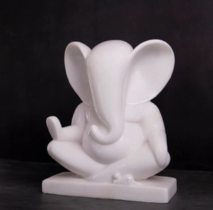 White marble statue of Sai Baba of Shirdi seated in his signature posture, displayed on a glass coffee table. - Product Image 2