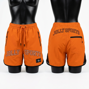 Shorts cortavientos de poliéster ligero premium de 110 GSM, color naranja, con paneles laterales de malla, logotipo con estampado de diamantes de imitación, bolsillo con cremallera, para mujer. - Product Image 1