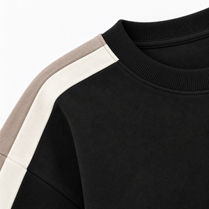 Sudadera negra para mujer con rayas en contraste y paneles de manga en blanco y taupe, cuello redondo oversize, puños acanalados, top deportivo informal para el día a día. - Product Image 3