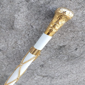 This luxury <b>white</b> walking stick features an ornate gold knob handle with decorative <b>hanging</b> chains available at wholesale prices - Product Image 1