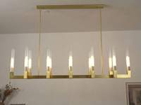 Lustre linéaire LED de luxe en métal et verre transparent avec hauteur réglable et longueur personnalisable pour projets hôteliers et de villas