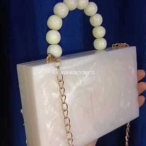 Elegant white resin clutch with beaded handle, <b>crystal</b> embellishments, and gold chain for weddings and parties. - Product Image 2