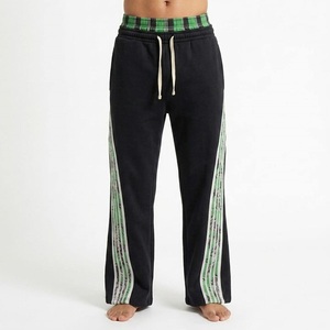 Pantalon de survêtement noir pour homme avec bandes latérales vertes, taille élastique et cordon de serrage, style décontracté, idéal pour l'automne - Product Image 1