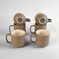 Ensemble de 6 tasses en porcelaine fine côtelées aux tons terreux, finition mate, compatibles micro-ondes, motif logo, style minimaliste, idéal pour offrir
