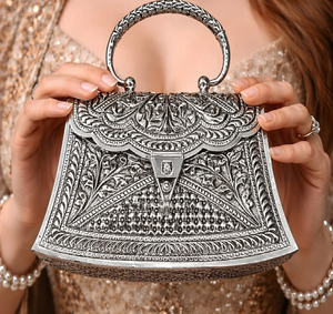 Trapezoidal <b>silver</b> brass hand <b>clutch</b> featuring a scalloped flap, textured geometric lower panel, leaf border,at wholesale prices - Product Image 1