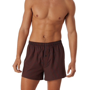 Calzoncillos bóxer sin costuras de cintura media para hombre, de tela de punto transpirable, de secado rápido, con logo digital impreso en la cintura y patrón liso. - Product Image 1