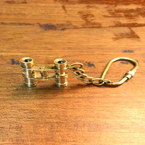 Miniature vintage brass binocular <b>keychain</b> accessory with a sturdy brass clip, available at wholesale prices. - Product Image 1