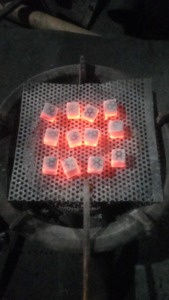 Our Indonesian-produced coconut shell charcoal <b>cube</b> briquettes <b>light</b> up quickly. - Product Image 6
