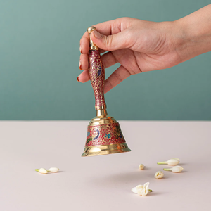 Traditional brass hand bell adorned with vibrant red and blue enamel artwork, available at wholesale prices. - Product Image 1