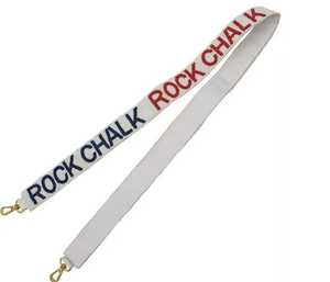 Correa blanca Rock Chalk con texto rojo y azul y ganchos dorados para bolso o accesorio de cámara - Product Image 1