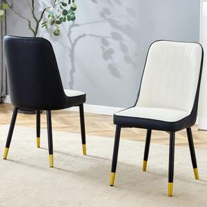 Moderne sedie da pranzo in PU bicolore bianco e nero con gambe decorate in oro Set di 2 - Product Image 1