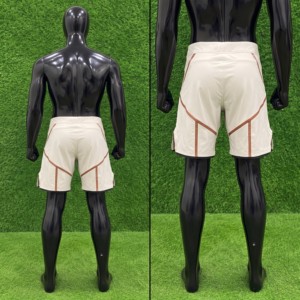 Shorts de MMA pour hommes Topline Products, coupe athlétique, anti-humidité, séchage rapide, respirant, blanc avec bordure orange. - Product Image 3