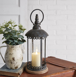 Ornate <b>Moroccan</b> style lantern showcases intricate black metal filigree and warm amber glass, available at wholesale prices. - Product Image 4